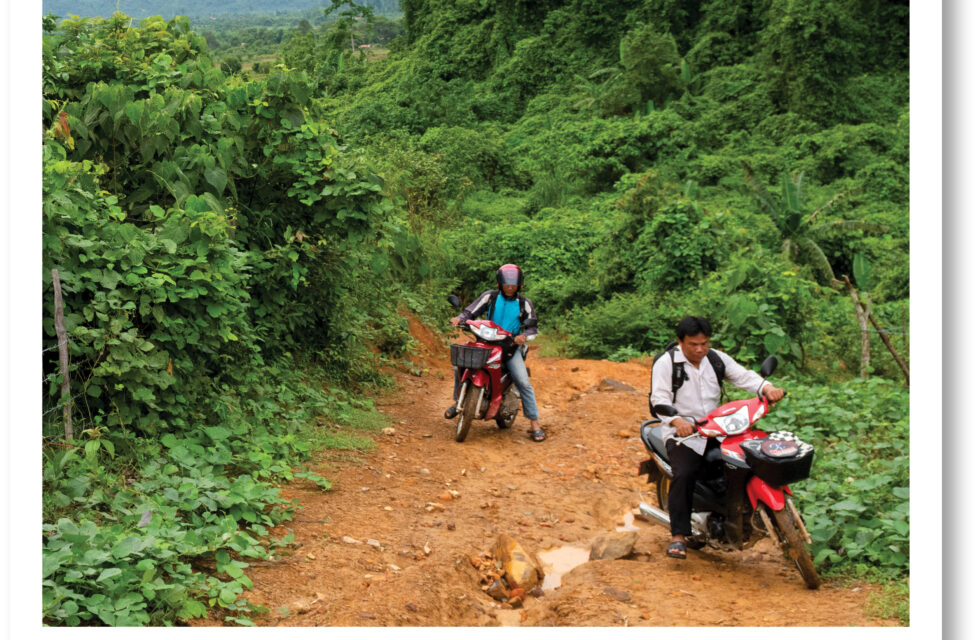 Sharing Jesus in a Vietnamese Communist Hero Village Two men riding motorbikes up a hill