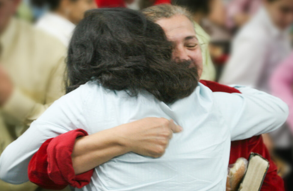 Young Egyptian Believer Abandoned and Abused By Family Two Women hugging at a church service
