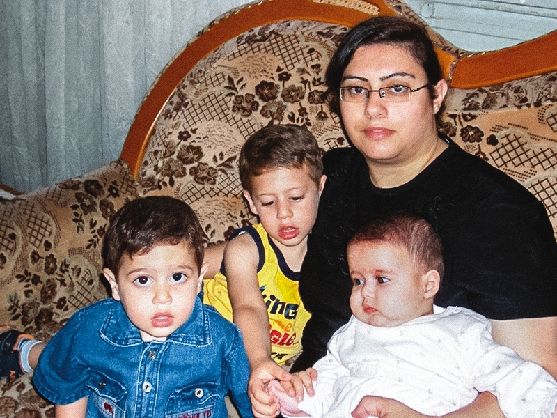 a picture of Pauline and her three children sitting on a couch